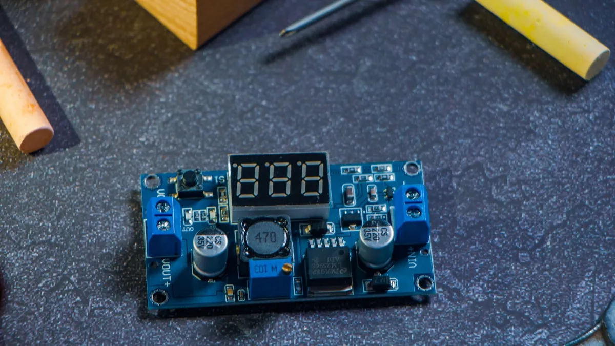 Two small LoRa development boards with OLED screens and antennas on a wooden workbench